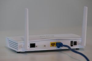 WiFi router on shelf in Melbourne home, illustrating dead zone fix guide by Dtech IT Solutions